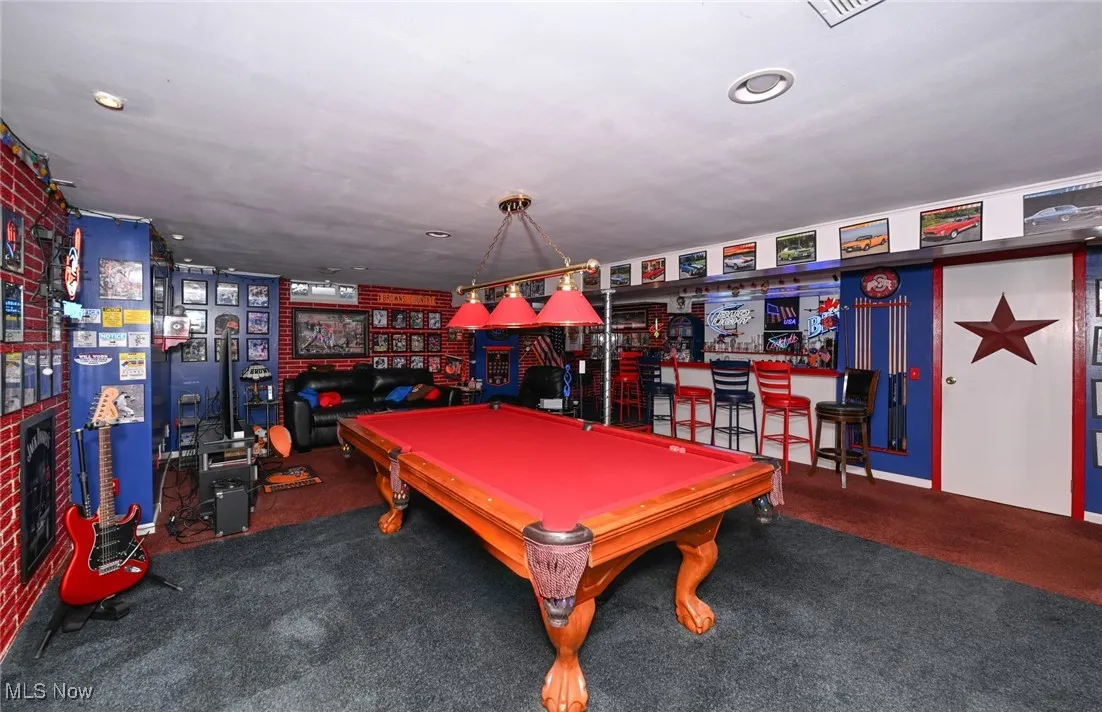 Recreation room with poured foundatiuon hand painted to mimic a brick wall.