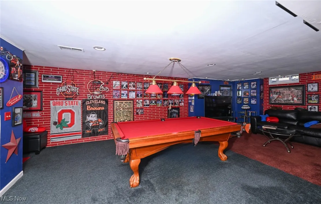Rec room featuring billiards table, a bar, recessed lighting and sports memorbilia.