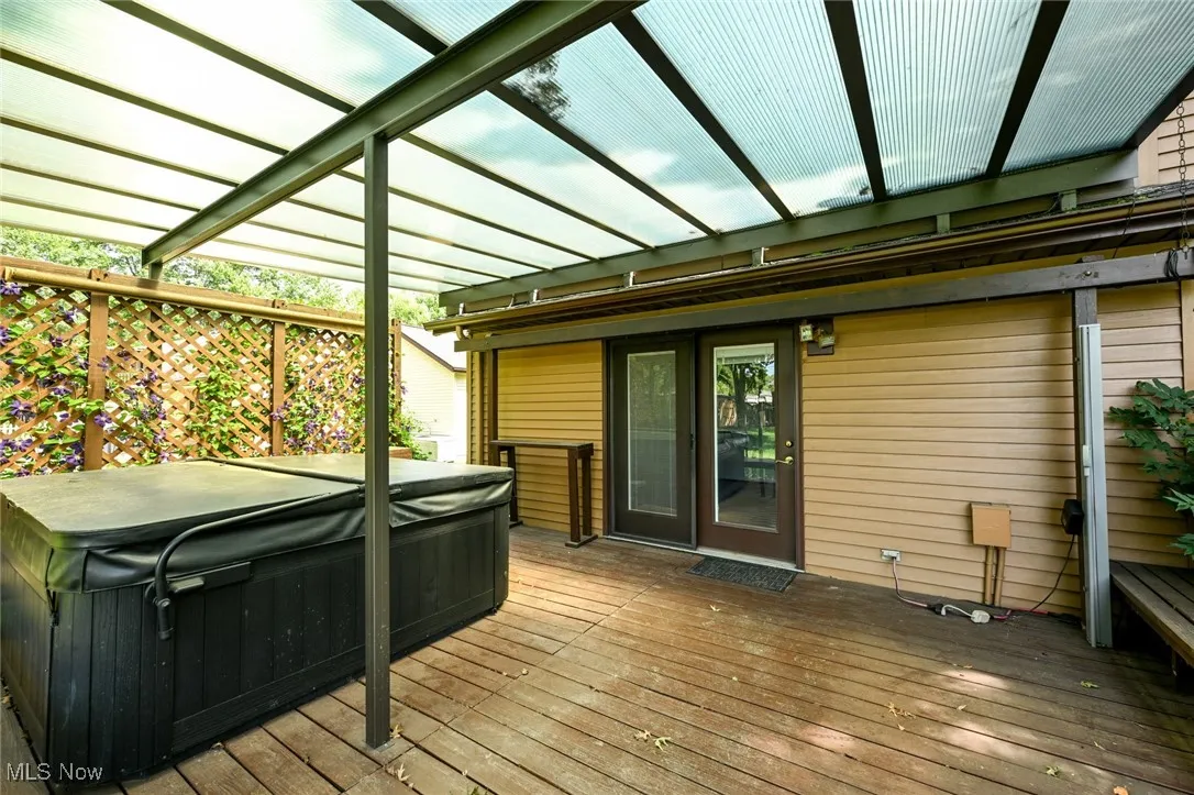 Wooden deck featuring a hot tub