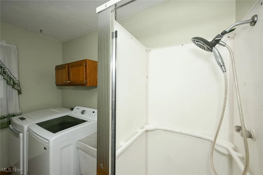 First floor laundry, featuring walk-in shower