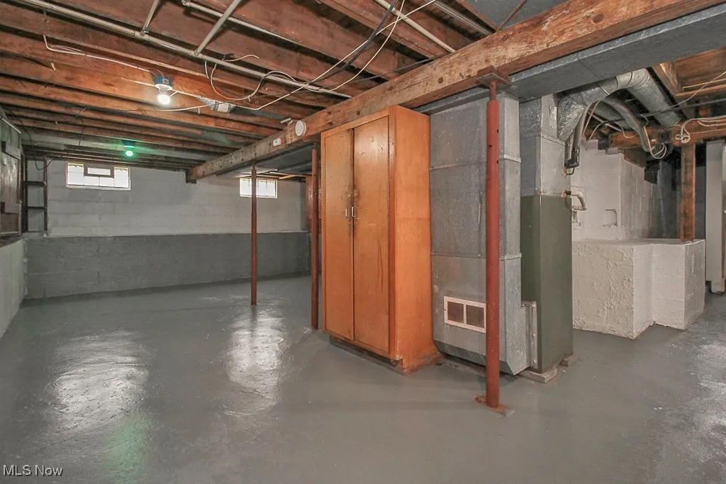 Basement featuring heating unit