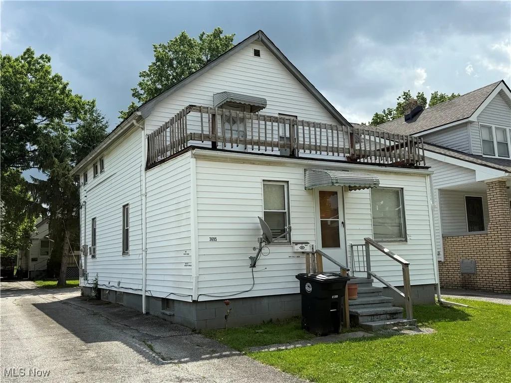 View of front of property with a balcony