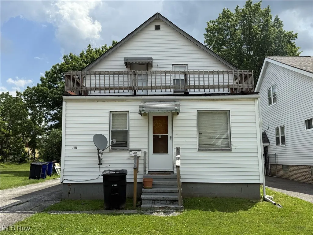View of front of property with a balcony