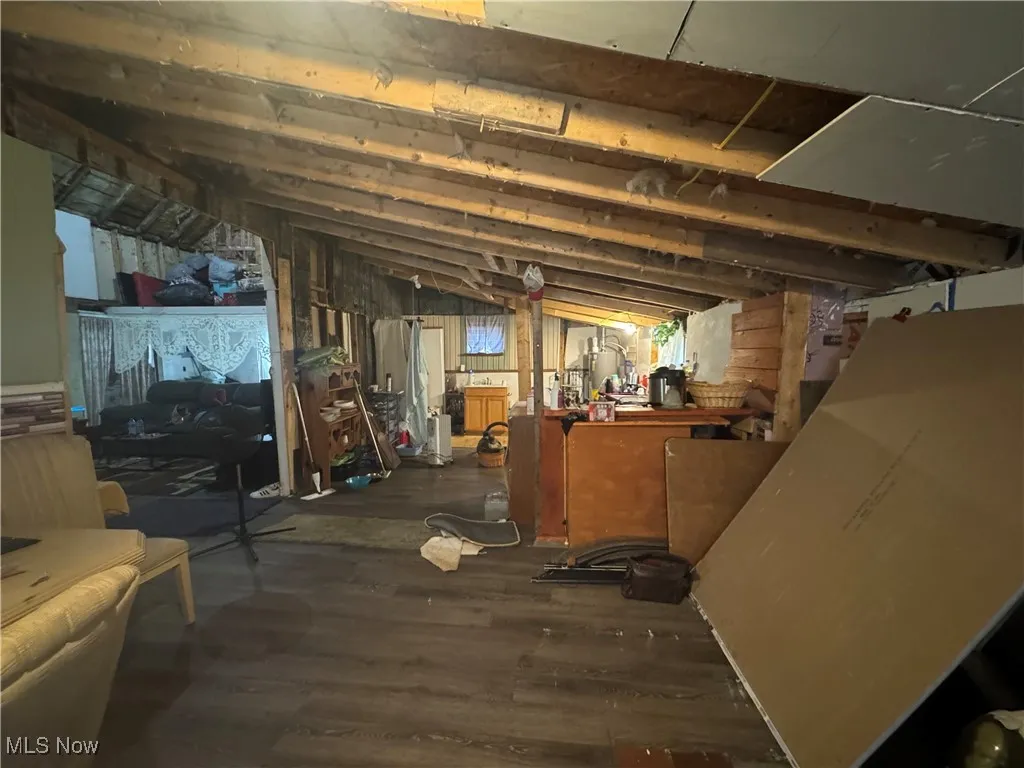 Unfinished below grade area featuring wood finished floors