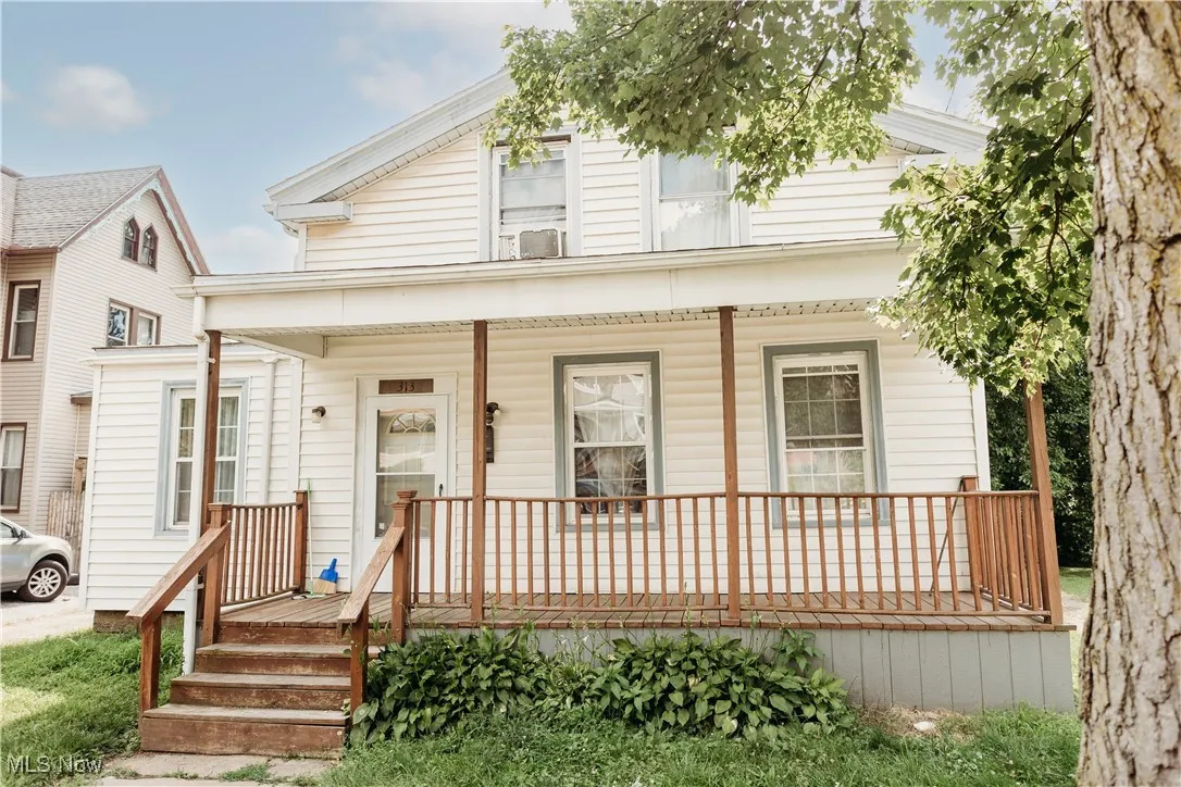 View of front of home featuring covered porch and cooling unit