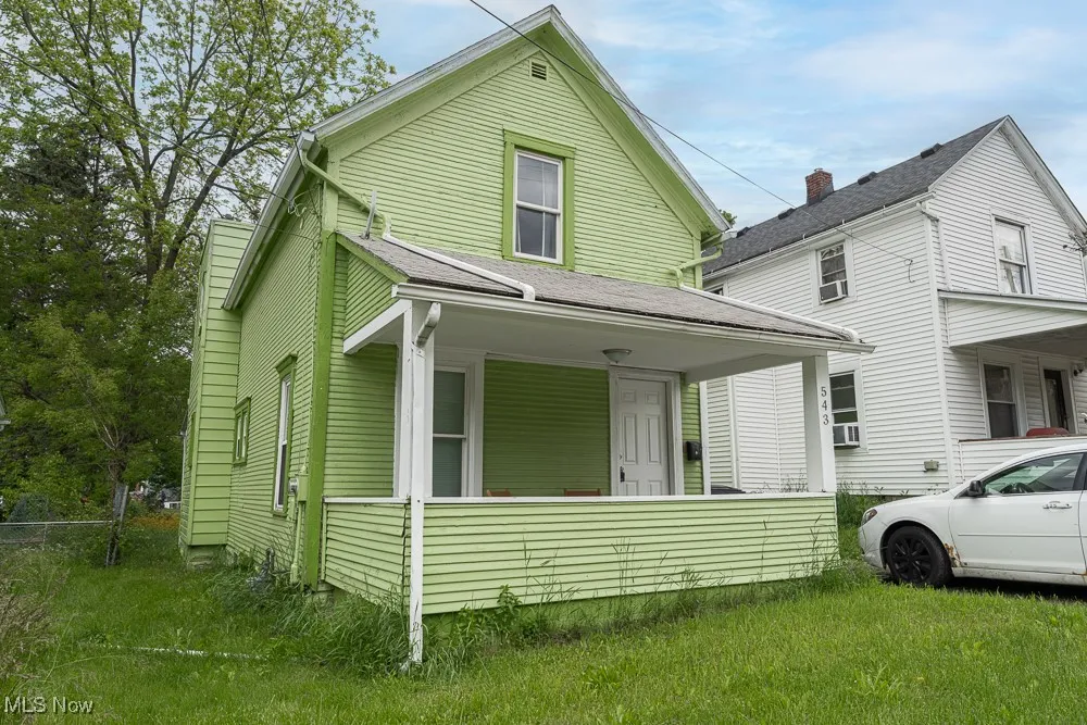 View of front of home with covered porch and cooling unit