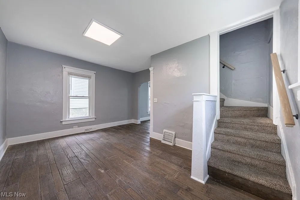 Stairway with hardwood / wood-style floors and baseboards