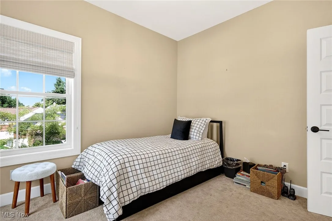 Bedroom featuring carpet flooring and multiple windows