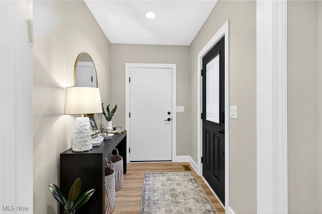 Foyer entrance with light wood-type flooring and recessed lighting
