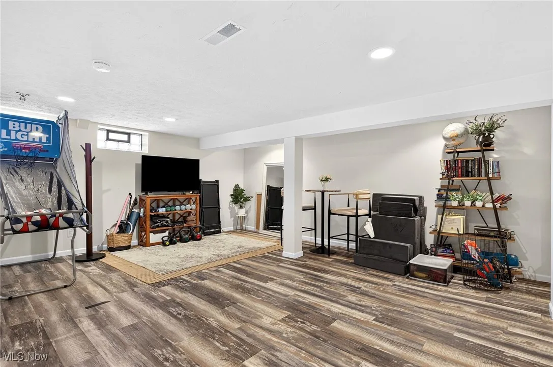 Living area featuring wood finished floors and recessed lighting