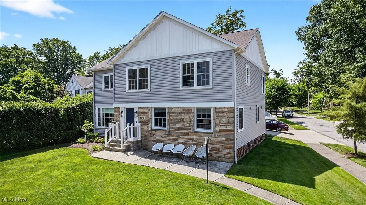 View of front of home featuring a front yard and stone siding