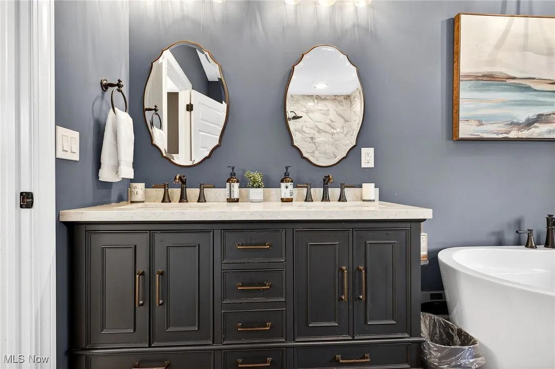 Full bathroom with double vanity and a freestanding bath