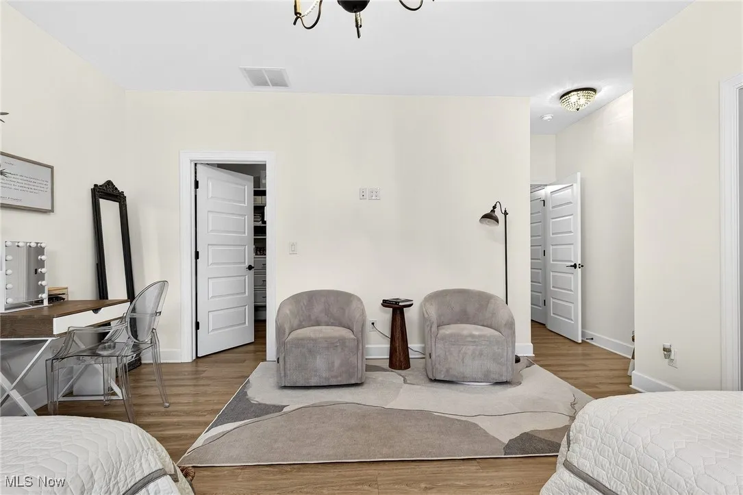 Bedroom featuring wood finished floors and a desk