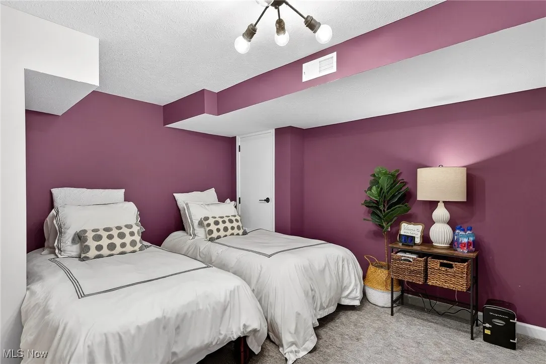 Bedroom featuring carpet flooring and a textured ceiling