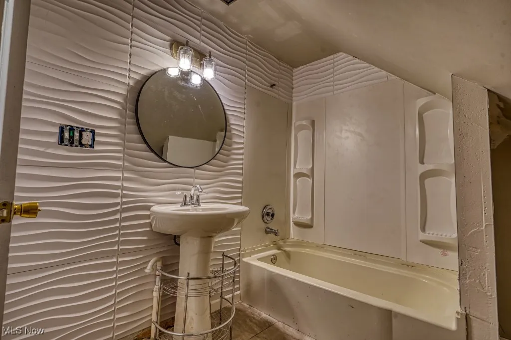 Full bathroom with  shower combination and tile patterned flooring