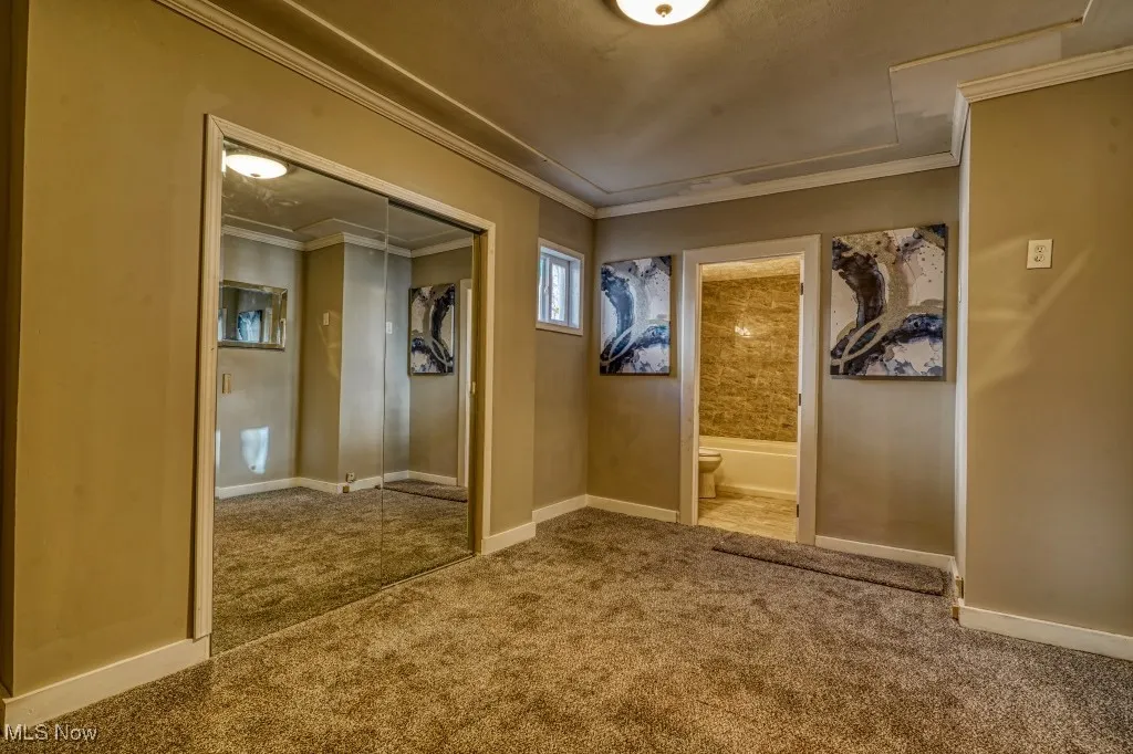 First Floor Master bedroom featuring carpet flooring and crown molding