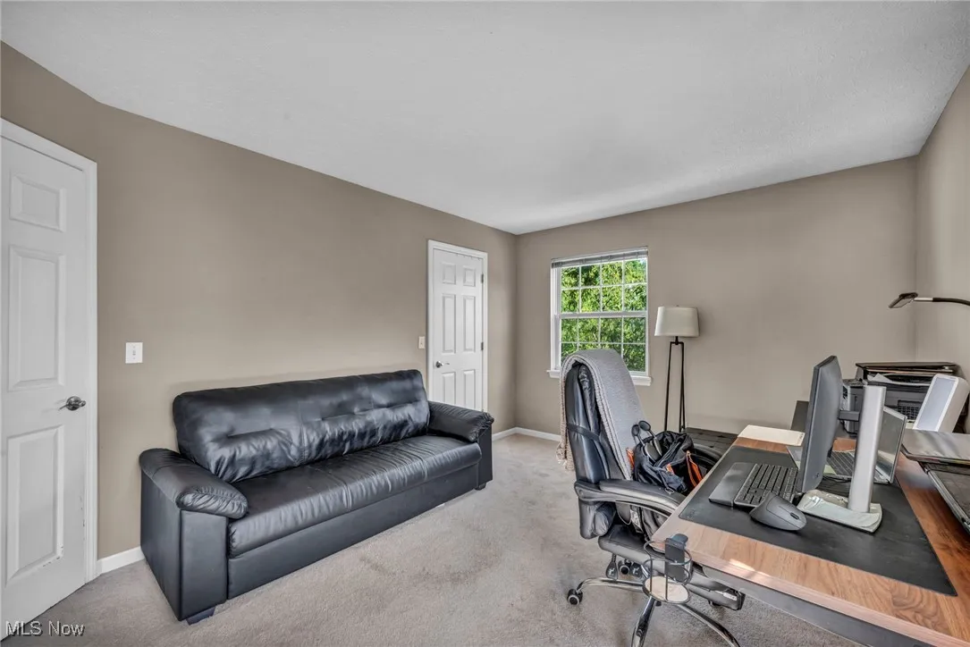 Carpeted office featuring baseboards