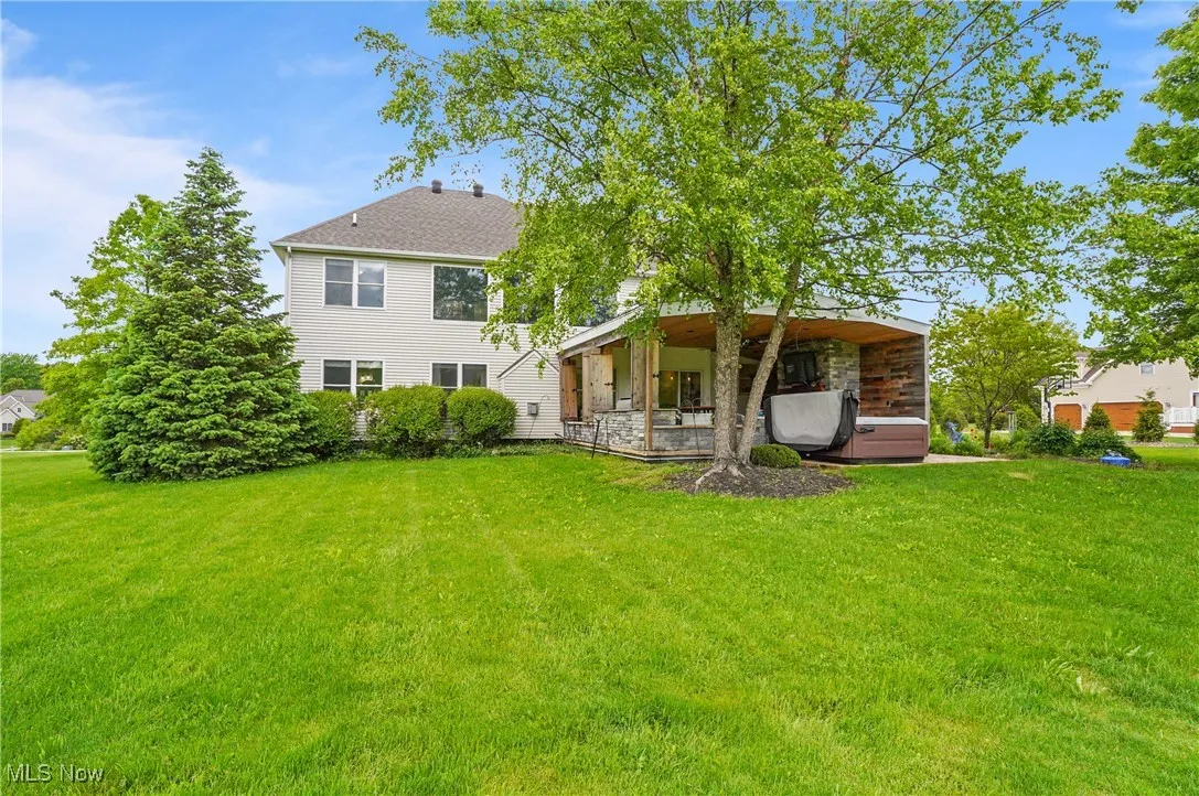 Back of house featuring a yard and covered patio