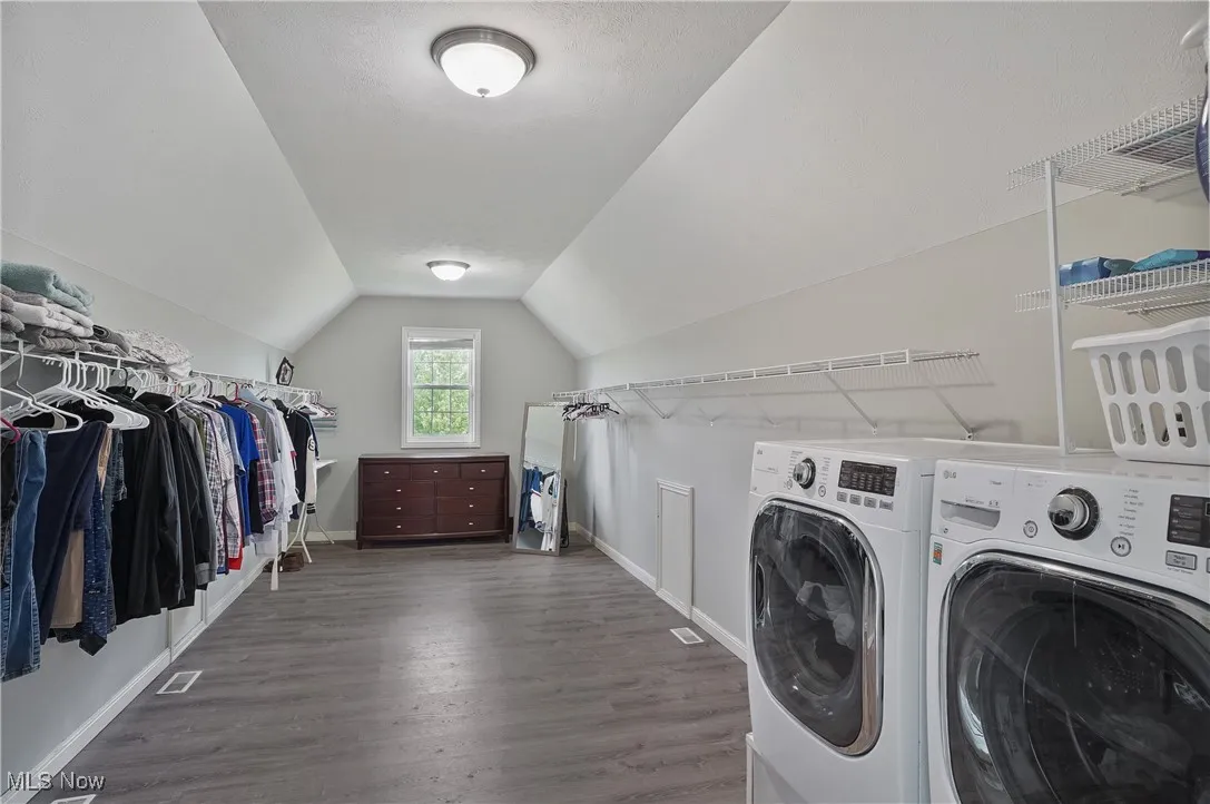 dream walk in closet with Laundry room featuring washer and dryer and lvt floors