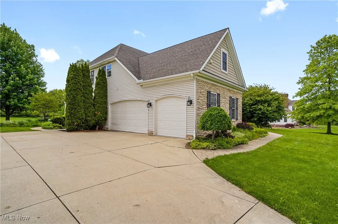 View of side of home and 3 car garage