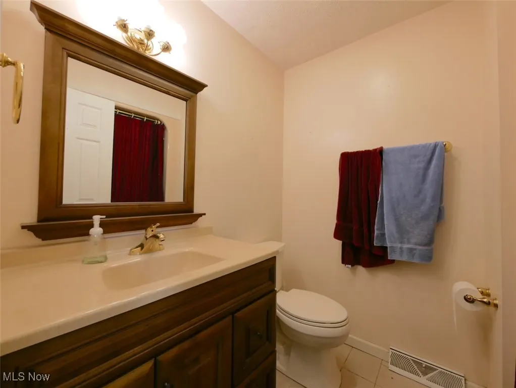 Bathroom with vanity and tile patterned floors