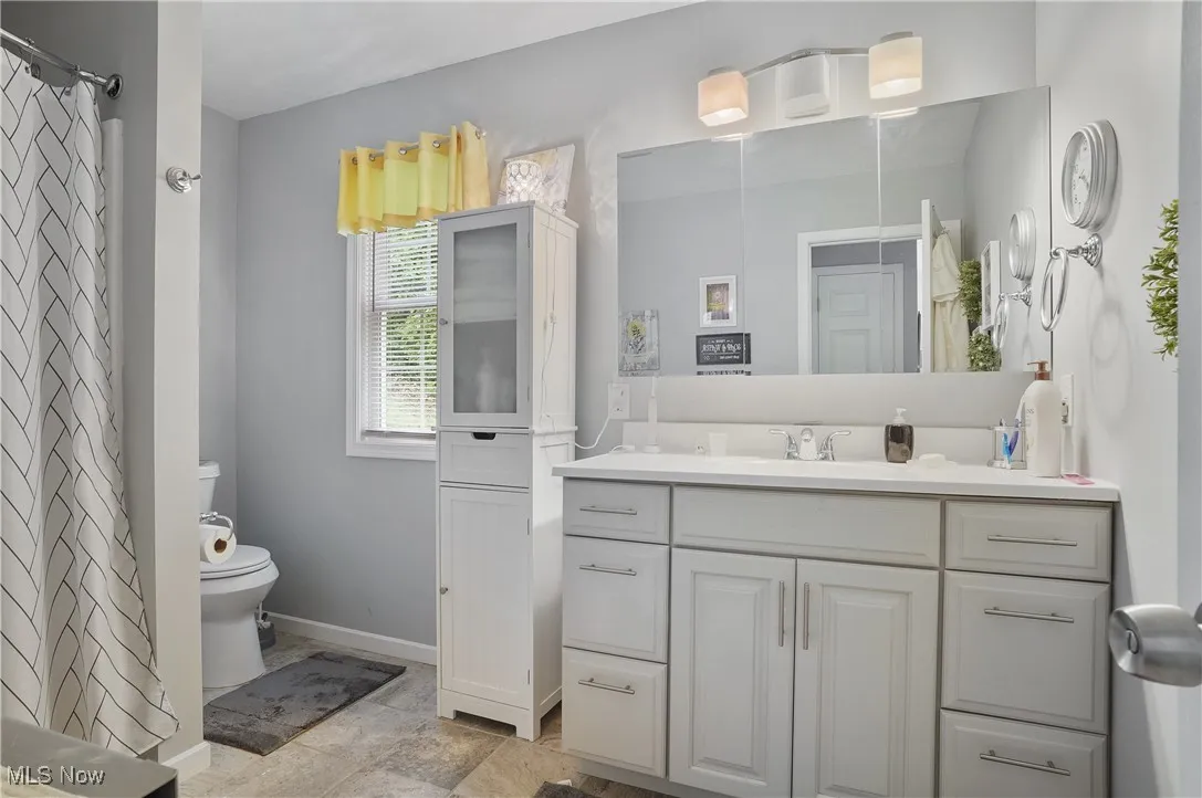 Full bath with vanity and curtained shower