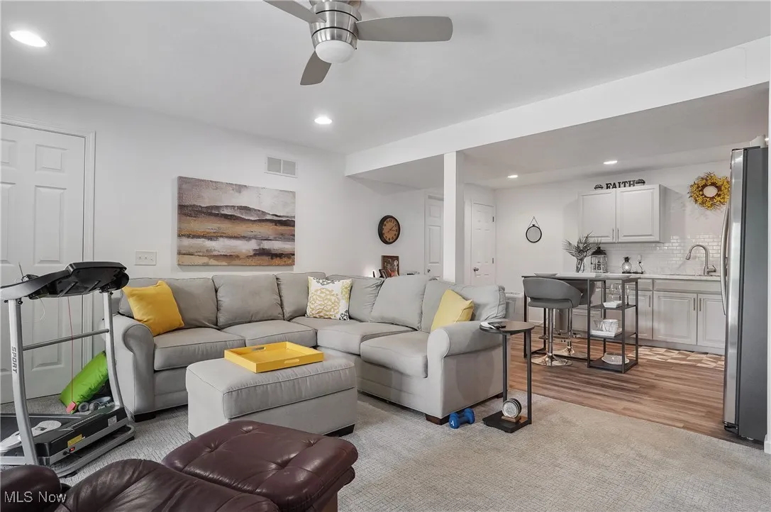 Living area featuring recessed lighting, ceiling fan, and light wood finished floors