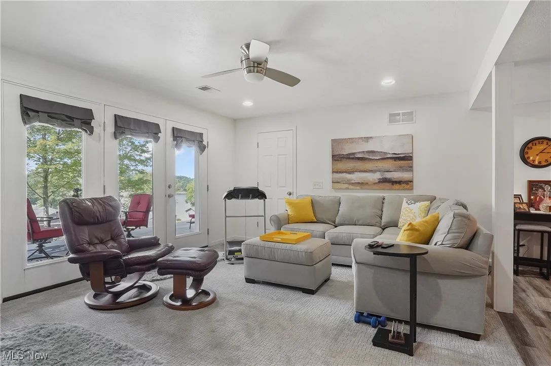Living room with ceiling fan and recessed lighting