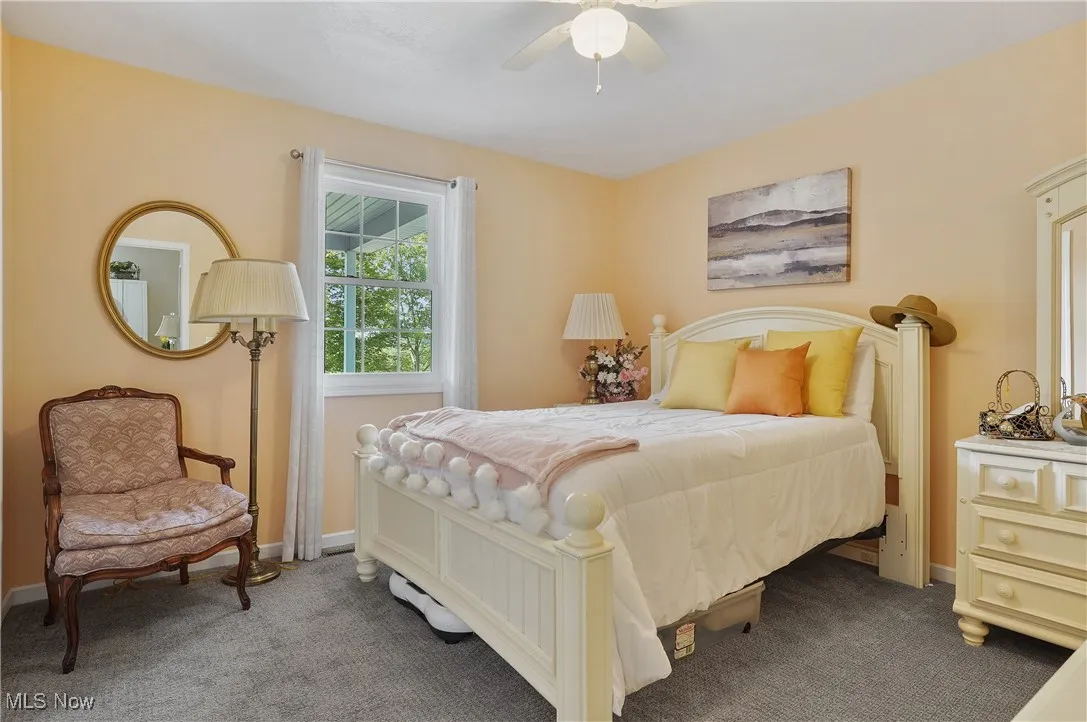 Bedroom with carpet and ceiling fan