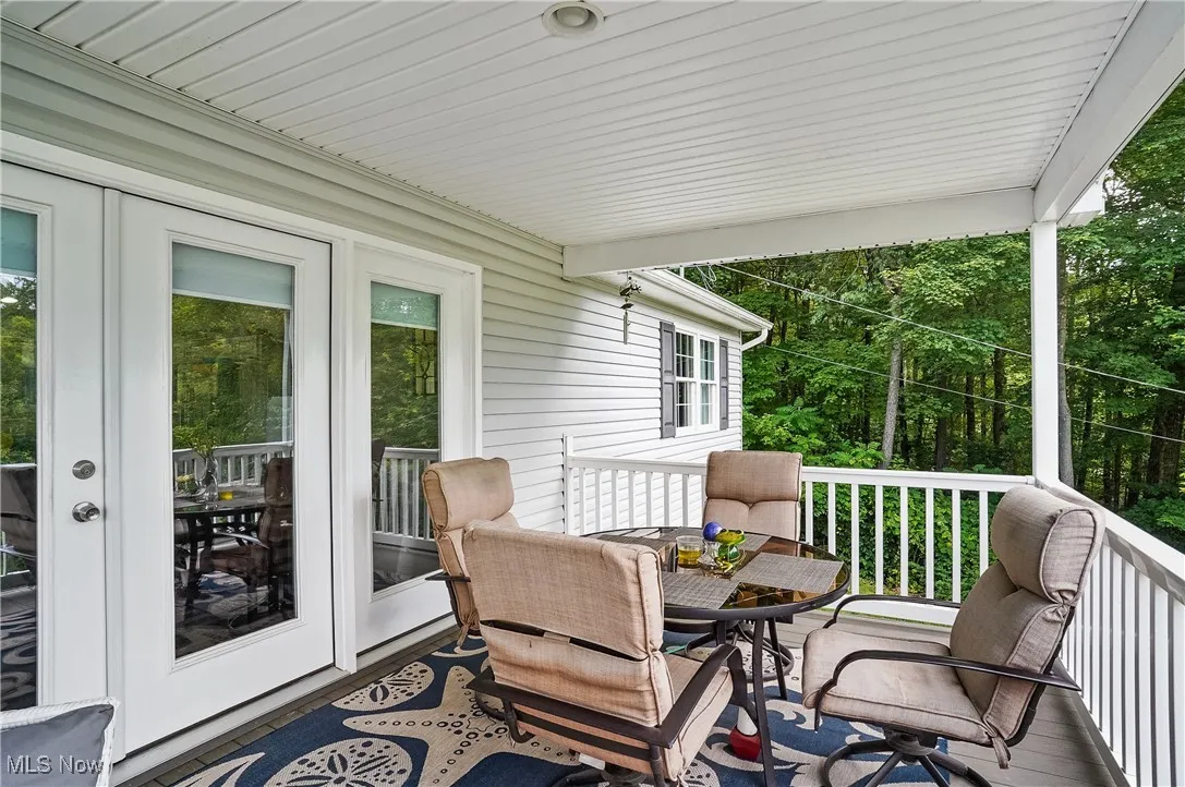 Deck with french doors and outdoor dining space