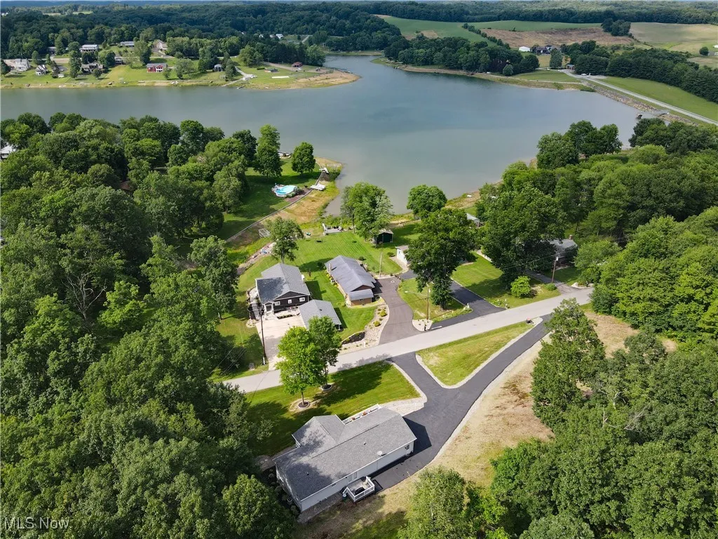 Aerial view of property and surrounding area featuring a 150 acre lake