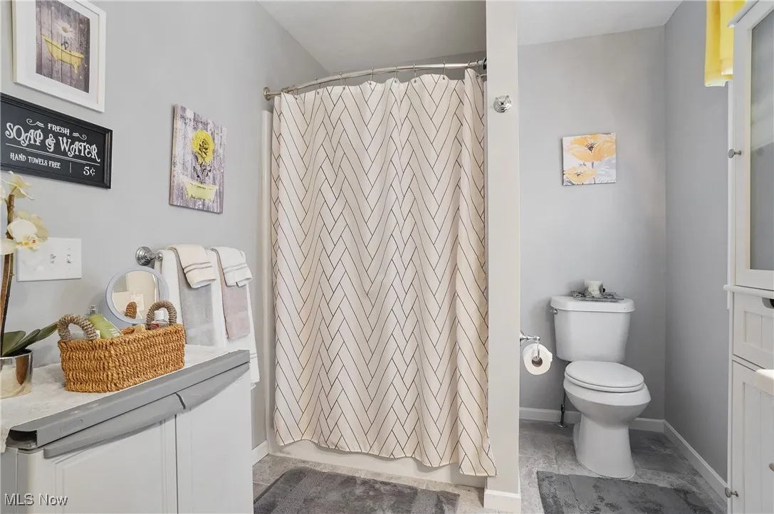 Full bathroom with vanity and a shower with shower curtain