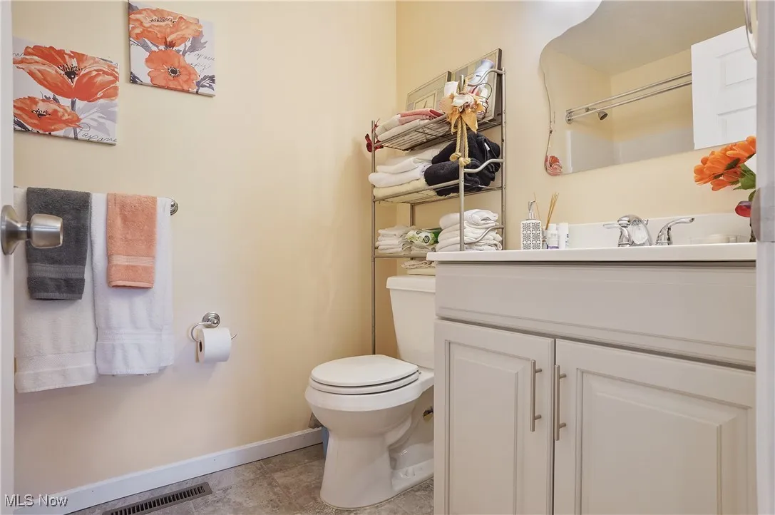 Bathroom featuring baseboards and vanity