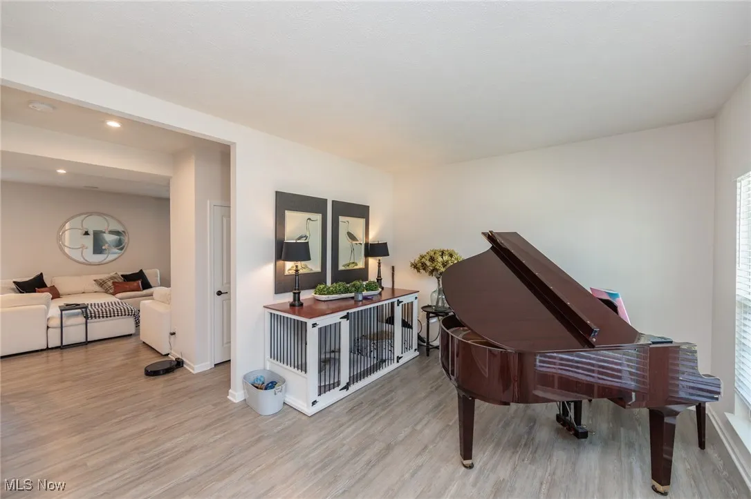 Living area featuring wood finished floors and recessed lighting