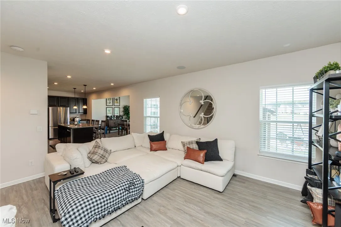 Living area featuring light wood-style floors and recessed lighting