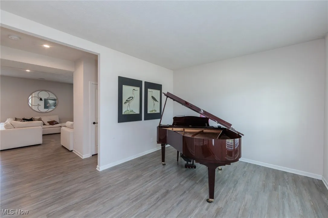 Sitting room with wood finished floors and recessed lighting