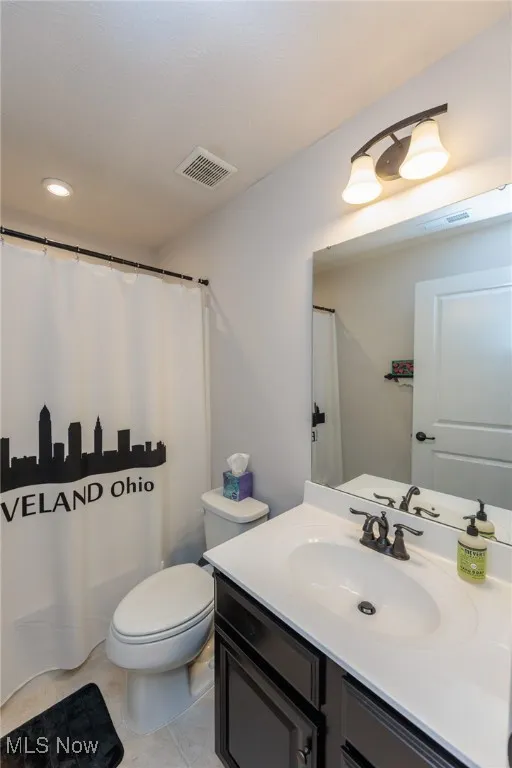 Full bath with vanity, tile patterned flooring, curtained shower, and recessed lighting