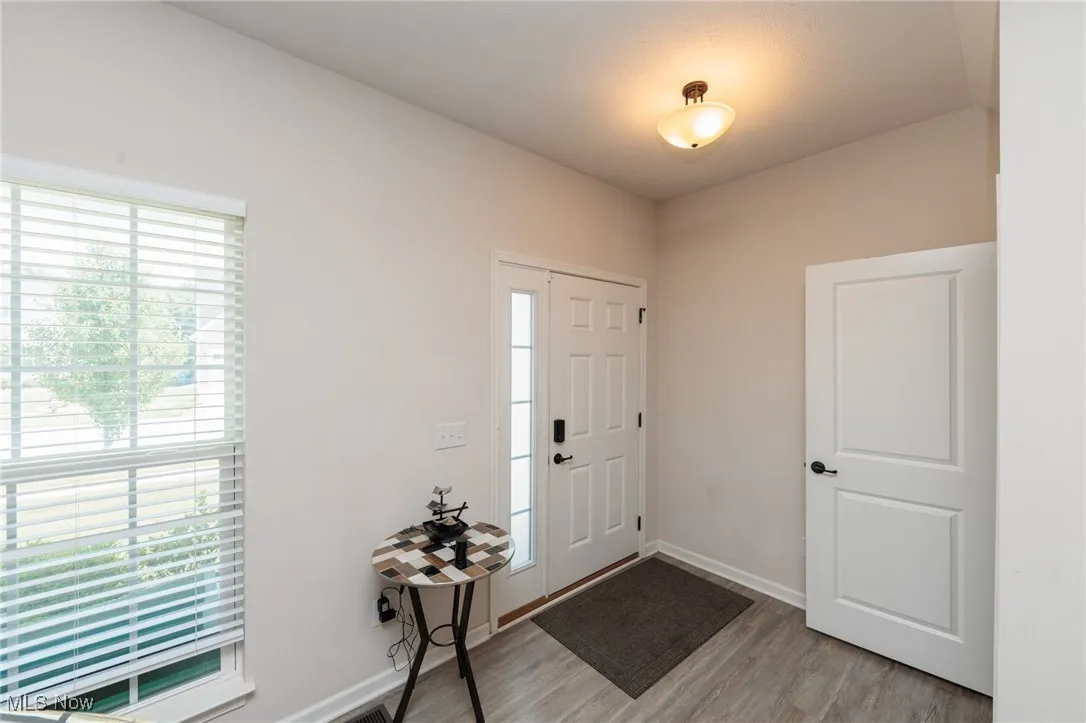 Entrance foyer featuring wood finished floors and baseboards