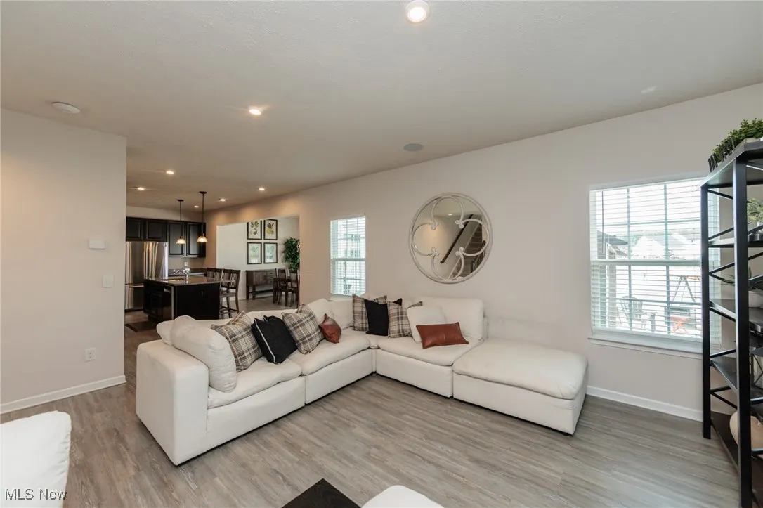 Living area featuring light wood finished floors and recessed lighting
