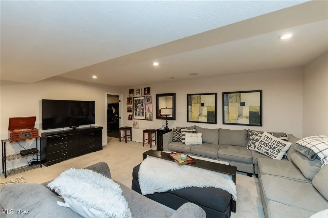 Living room featuring light colored carpet and recessed lighting