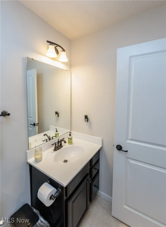Bathroom featuring vanity and tile patterned floors