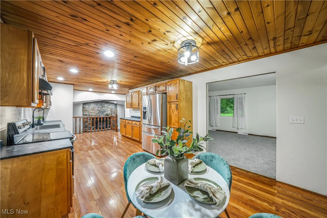 Dining room with wood ceiling, light wood finished floors, and recessed lighting