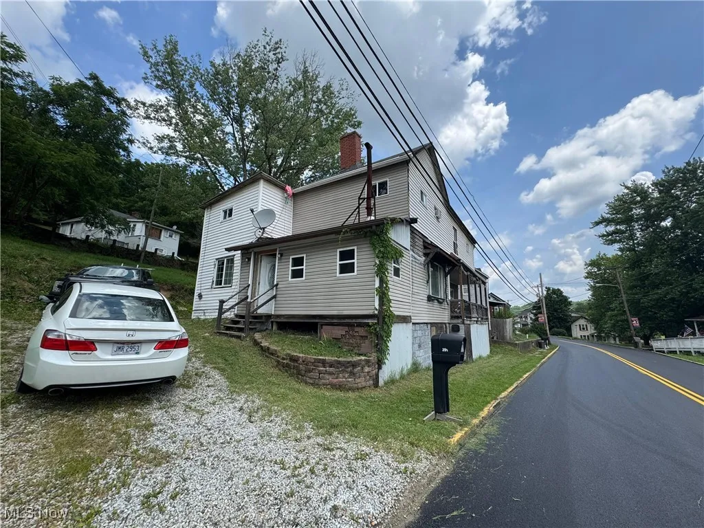 View of front of home featuring a chimney