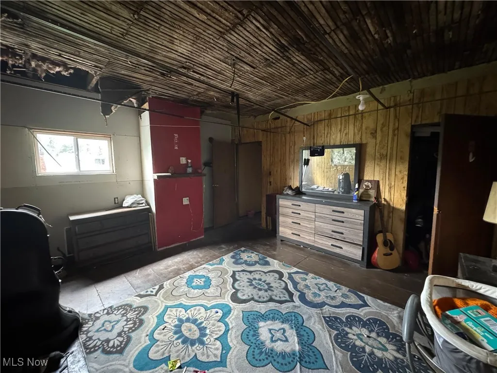 Bedroom featuring wooden walls