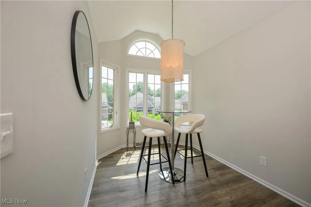 Dining room with vaulted ceiling and wood finished floors