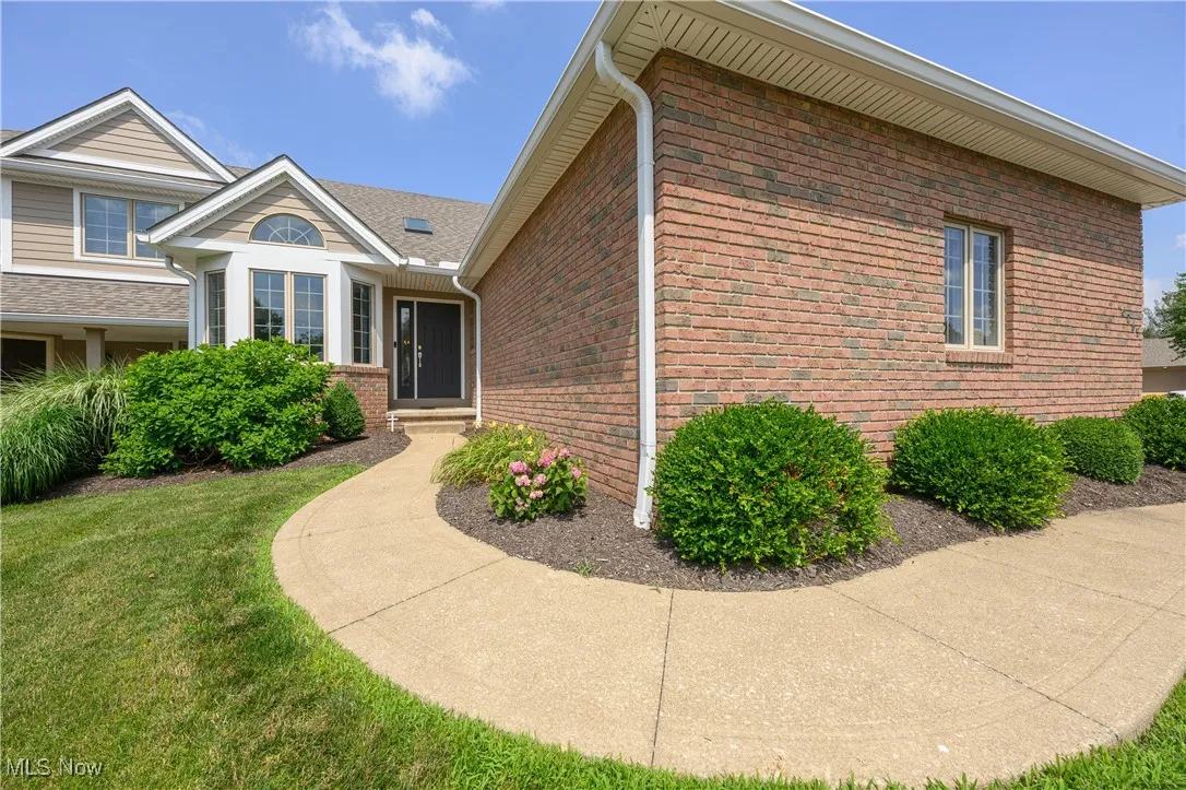 View of home's exterior featuring brick siding and a yard