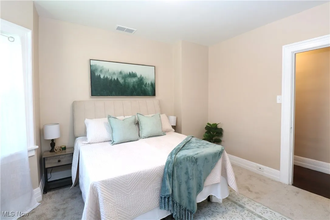 Carpeted bedroom featuring baseboards