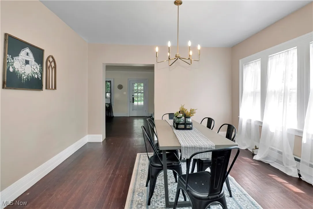 Dining room featuring a chandelier and dark wood-type flooring