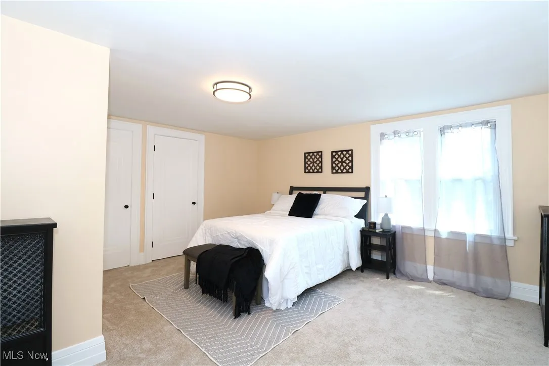 Bedroom with carpet flooring and baseboards
