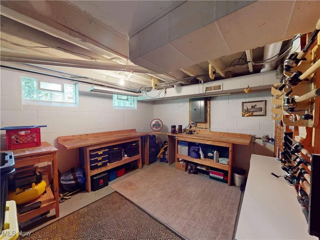 Basement with a workshop area and electric panel